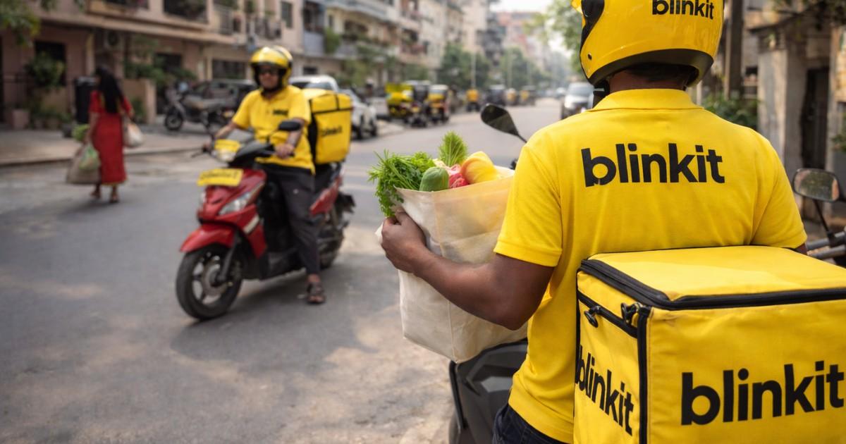 Blinkit 10 minute delivery rider transporting groceries in an urban Indian neighbourhood