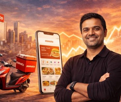 Deepinder Goyal, Zomato founder and CEO, standing confidently with a Zomato delivery scooter and smartphone app in the background, highlighting his leadership in India’s food-tech industry.